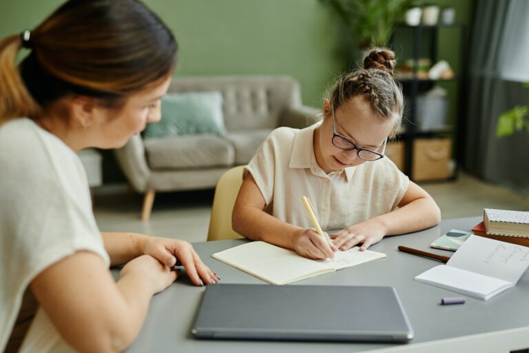 Girl with Down Syndrome Studying with Tutor